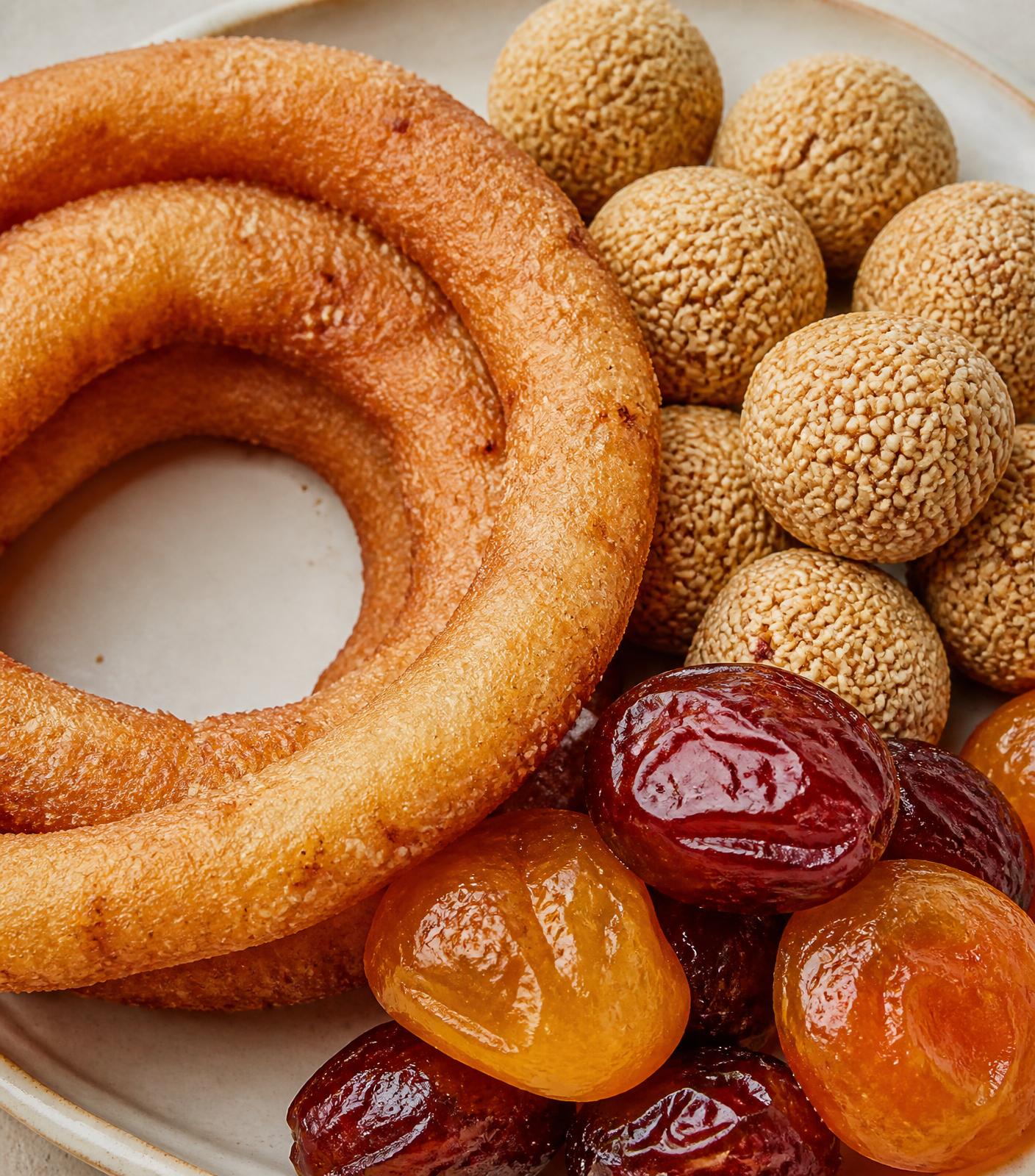 Freshly made Nepali confections arranged on an ivory ceramic plate
